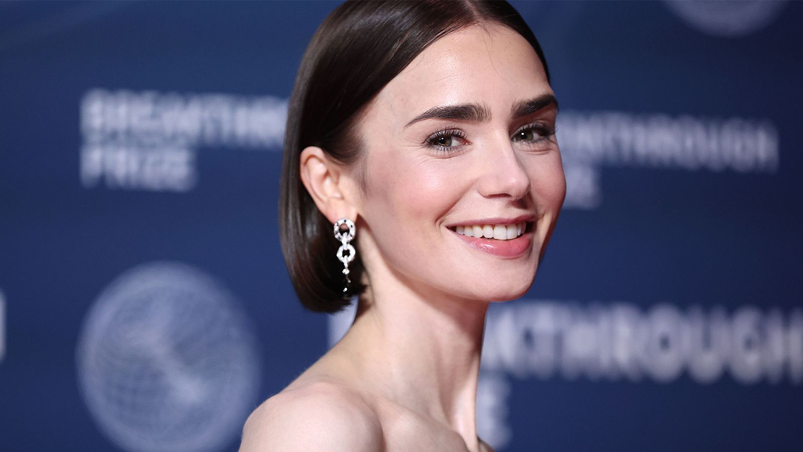 lily collins lacht in die kamera